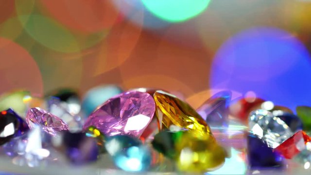 gemstones are showing on rotating platform. new year 2018 on the back of gemstones. bokeh of colorful christmas shine on the end.