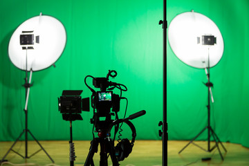 Studio for filming on a green background. The chroma key. Lighting equipment in the Studio. Green...
