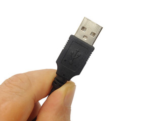 Hand holding black USB cable on white background photo.