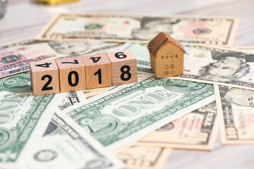 2018 new year cubes with the house model on group of cash