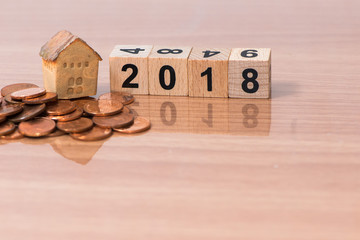 The wooden cube for new year with the house model and coins