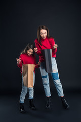 Daughter and mother looking into shopping bags