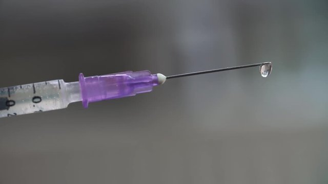 Medical syringe with drugs on blurry background