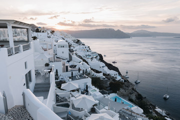 View of famous white buildings of Oia town on cliff in Santorini, Greece
