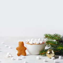 Christmas still life with cocoa, marshmallows, cinnamon and fir branches on blue backgroung. bright and festive. copyspace