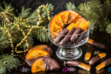 Chocolate candy, citrus fruit, dessert, oranges with Christmas symbols