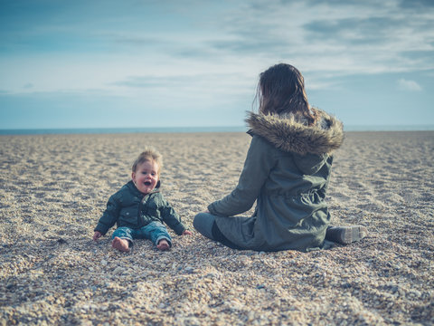 Mother with baby on the beach