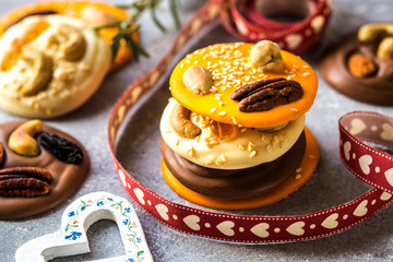 chocolate pieces, candies, sweets with nuts, candied citrus and spices with Christmas elements