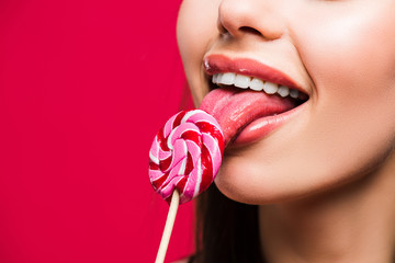 woman licking colored lollipop - obrazy, fototapety, plakaty