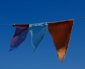 flags in the wind with blue sky