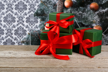 Christmas gifts on decorated tree background, holiday concept
