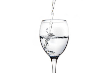 Wineglass with splashing drops of fresh water