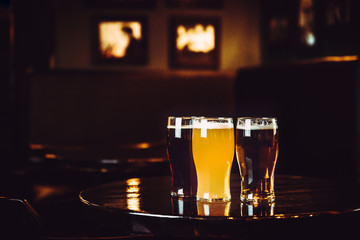 Glasses of light and dark beer on a pub background