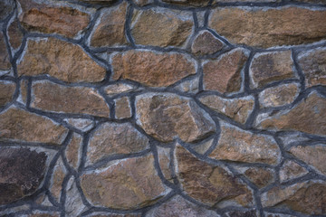 masonry slate facade wall background with cement joints antique. natural stone
