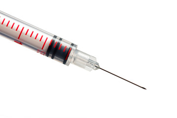 close up view of a red syringue needle on white background