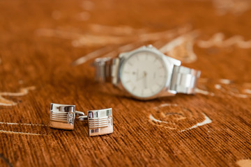 Tie, cufflinks and watches on the old wood background