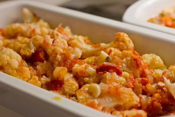 Salad from boiled cauliflower with red sweet pepper and olive oil