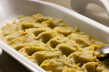 Jerusalem artichoke puree with herbs on a white plate