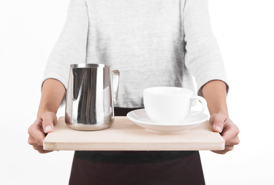 waitress in a apron with a tray in his hand cup coffee and milk pitcher. Service Concept