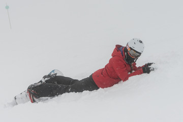 Snowboarder lying on snow , Whistler, British Columbia, Canada