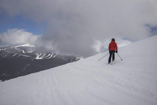 Tourist skiing on snowy mountain, Whistler, British Columbia, Canada