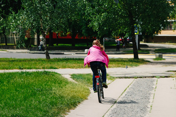 Girl with a guy riding in a park on a bicycle