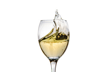 Wineglass with splashing drops of champagne