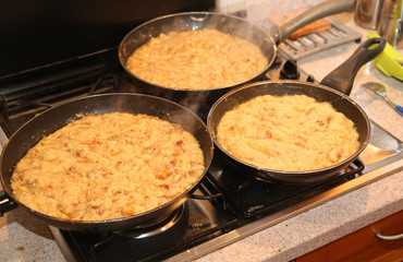 pans with the food named frico a typical italian dish with potat