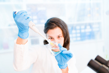 Young woman in microbiological laboratory