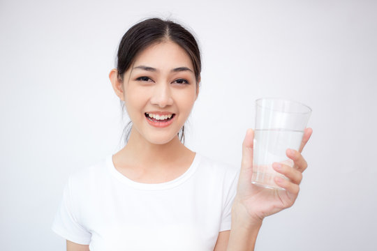Young Asian Woman holding water with smile on white background.