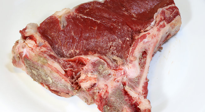 raw beef steak with a little fat ready to be cooked