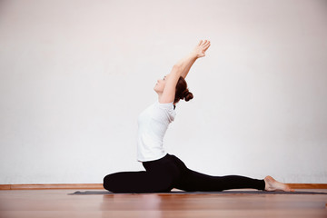 Yoga Concept. Close up woman meditates while practicing yoga in training hall or home.