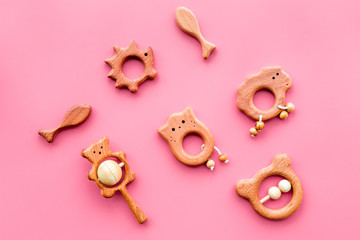 Simple handmade toys for newborn baby in shape of animals on pink background top view