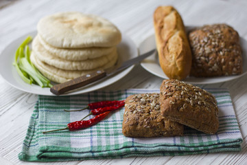 bread, baguette and chili on a wooden table