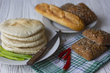 bread, baguette and chili on a wooden table