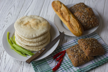 bread, baguette and chili on a wooden table