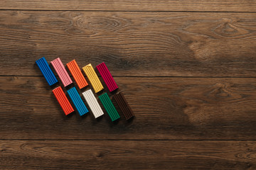 Obraz premium Colored clay lies on a wooden brown table. Copy space.