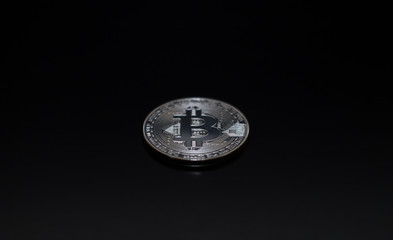 Bitcoin on a black background. Metal coin, crypto currency