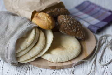 bread and bakery out of the bag on the table, Assortment of baked goods