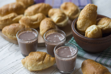 croissants and chocolate on white wooden table