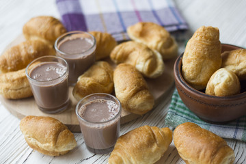 croissants and chocolate on white wooden table