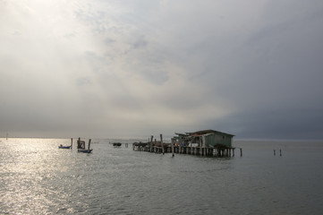 Wooden bricoles and wooden fishing house in the sea on the way from Chioggia to Venice