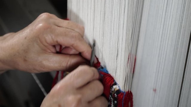 carpet weaving - manual manufacturing of oriental carpets. close-up shooting