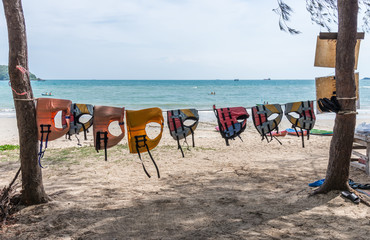 Colorful life jackets is hanging on the rope.