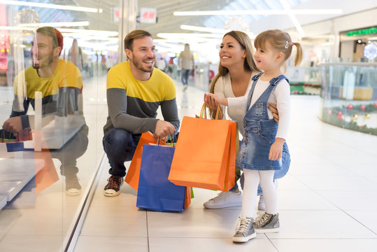 Happy family with child and shopping bags doing shopping 