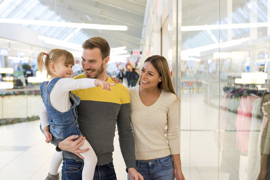Happy family with child doing shopping together in the shopping mall