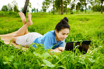 Naklejka na ściany i meble Business woman using laptop in the field