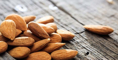 Almonds on an old wooden table, copy space