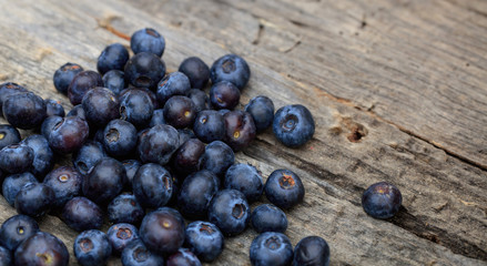 Stack of blueberries, on a wooden surface, copy space