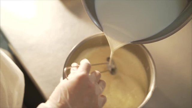 Ice-cream production. Mix ice cream. Pour the milk into a pan